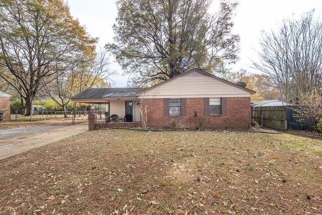 ranch-style home featuring a carport