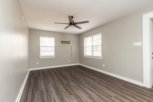 empty room featuring ceiling fan and dark hardwood / wood-style flooring