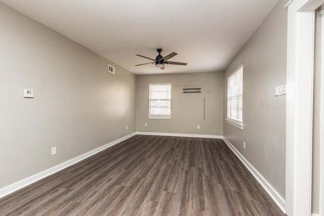 spare room featuring dark hardwood / wood-style floors and ceiling fan