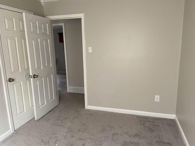 unfurnished room featuring light colored carpet