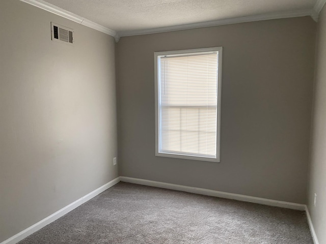 carpeted spare room featuring a textured ceiling and crown molding