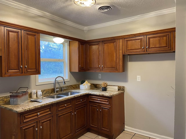 kitchen featuring crown molding, sink, light stone counters, and a textured ceiling