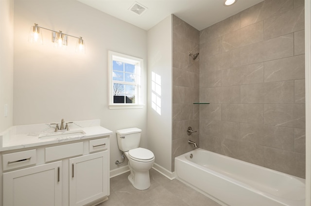 full bathroom with vanity, tile patterned flooring, tiled shower / bath combo, and toilet