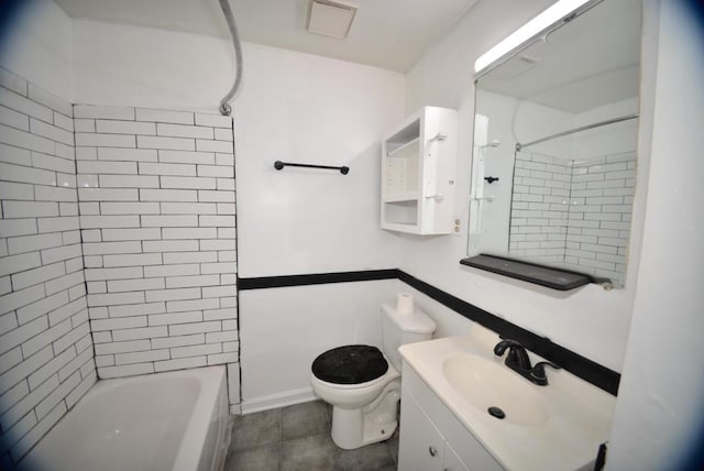 full bathroom featuring tiled shower / bath, vanity, and toilet