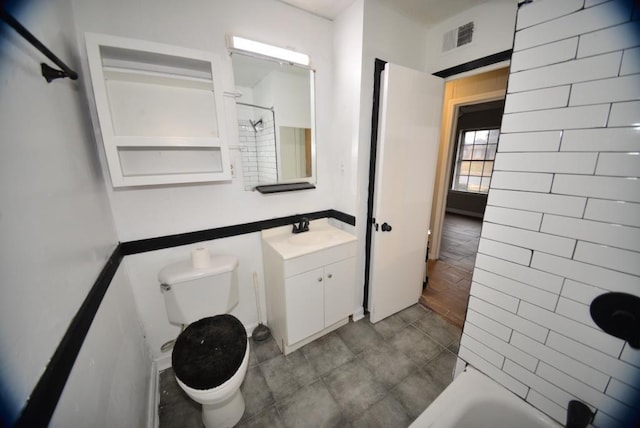 bathroom featuring vanity and toilet