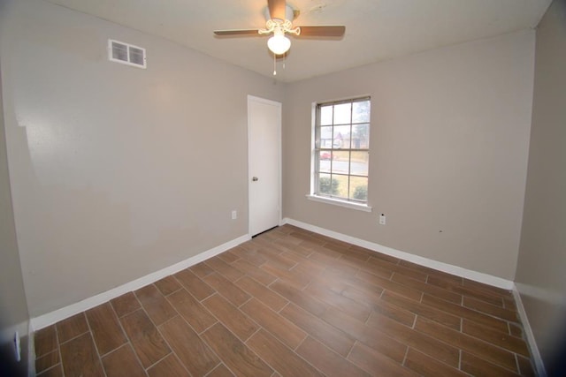 empty room featuring dark hardwood / wood-style floors and ceiling fan