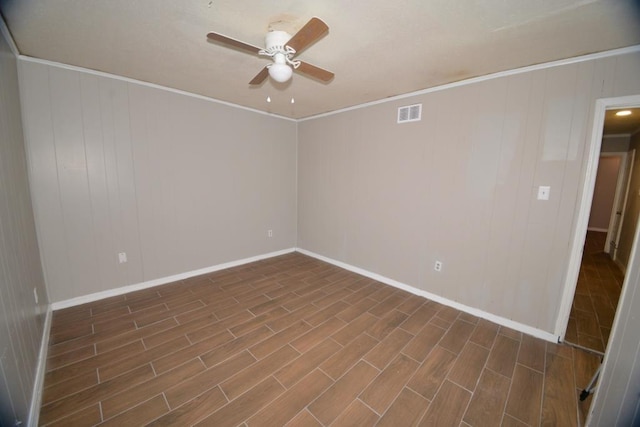 spare room featuring dark wood-type flooring, ceiling fan, and ornamental molding