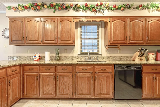 kitchen with light stone counters, black dishwasher, sink, and light tile patterned floors