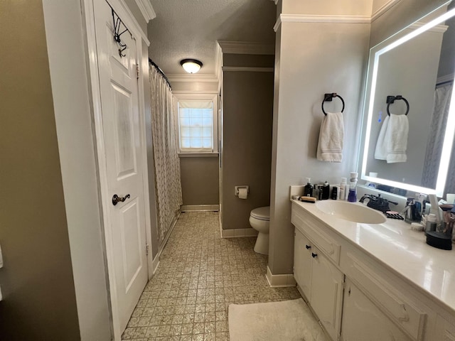 bathroom featuring crown molding, vanity, a textured ceiling, and toilet