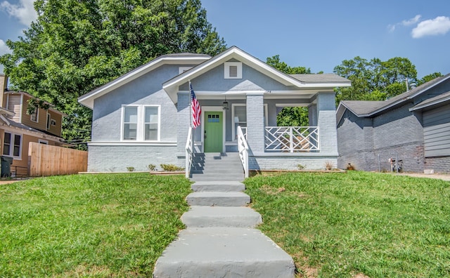 bungalow-style home with a front lawn and covered porch