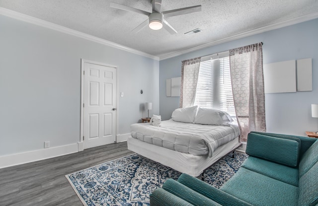 bedroom featuring a textured ceiling, crown molding, ceiling fan, and dark wood-type flooring