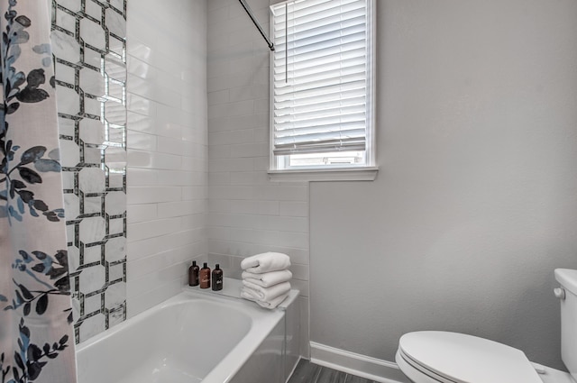 bathroom with hardwood / wood-style flooring, toilet, and shower / bathtub combination with curtain