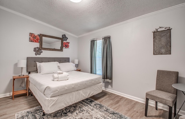 bedroom with hardwood / wood-style floors, lofted ceiling, ornamental molding, and a textured ceiling