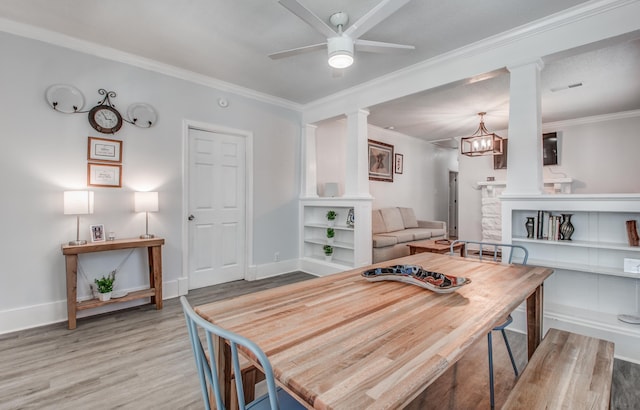 dining space featuring crown molding, light hardwood / wood-style floors, and ceiling fan with notable chandelier