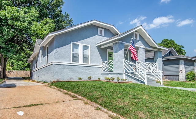 view of front of home with covered porch and a front yard