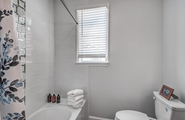 bathroom with shower / bath combo and toilet