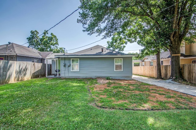 rear view of property with a lawn