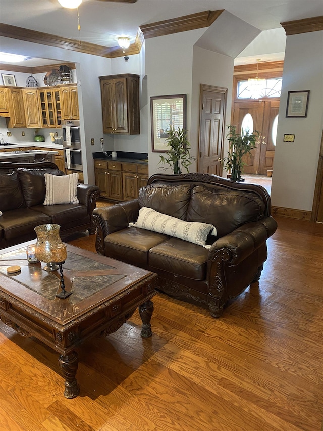 living room with wood-type flooring and ornamental molding