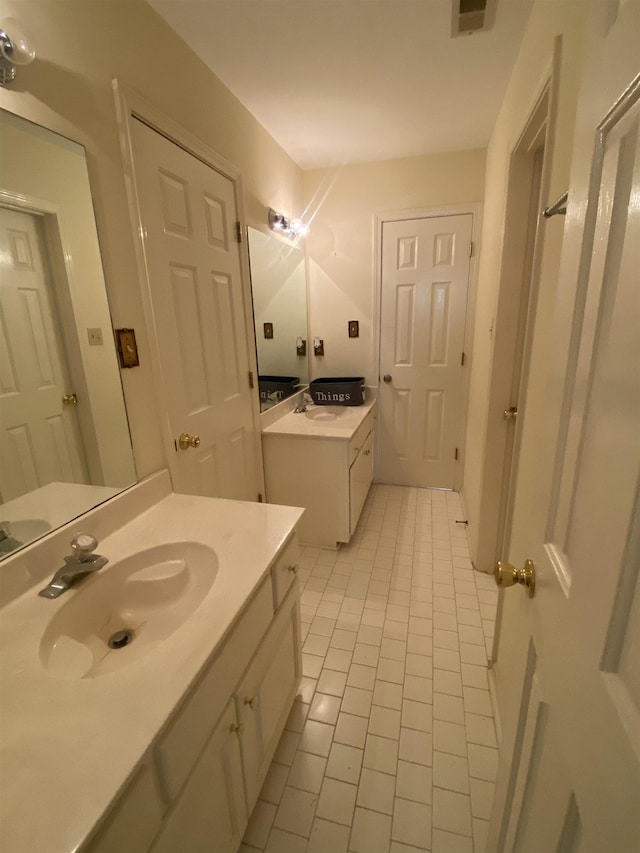 bathroom with tile patterned flooring and vanity