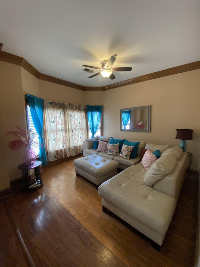 living room with a wealth of natural light, hardwood / wood-style floors, ceiling fan, and ornamental molding