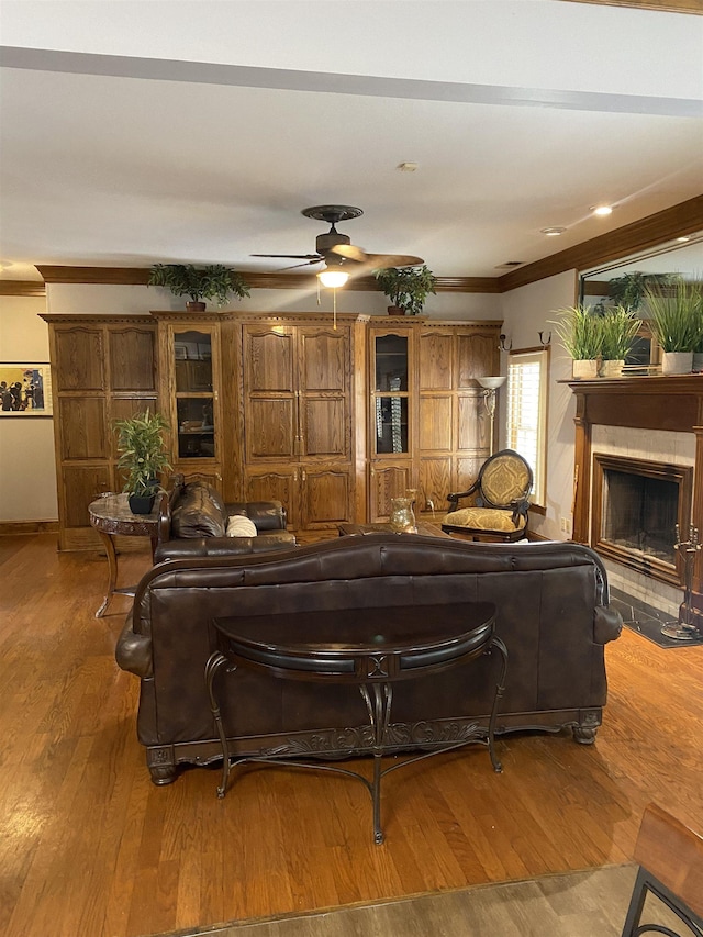 living room with ceiling fan, crown molding, and hardwood / wood-style flooring