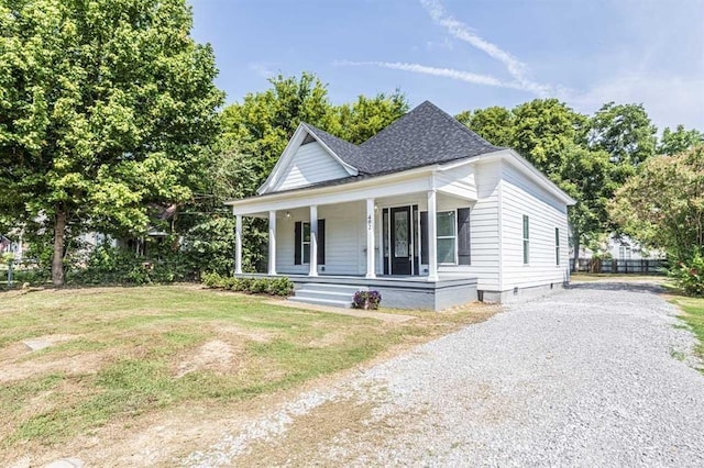 view of front of home featuring covered porch and a front lawn