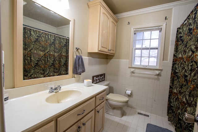 bathroom with crown molding, tile patterned floors, vanity, tile walls, and visible vents