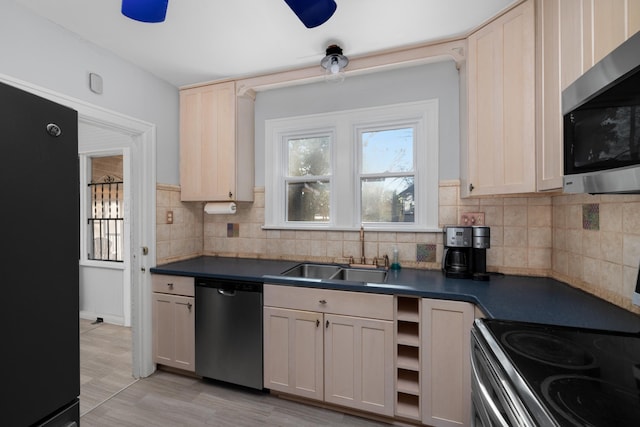 kitchen featuring sink, backsplash, and appliances with stainless steel finishes