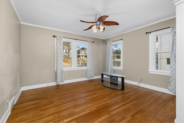 unfurnished room featuring ornamental molding, hardwood / wood-style flooring, ceiling fan, and a healthy amount of sunlight