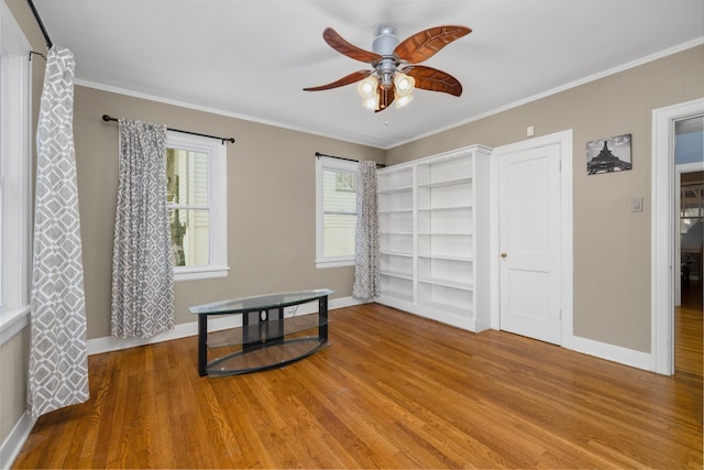 bedroom with wood-type flooring, ceiling fan, and ornamental molding