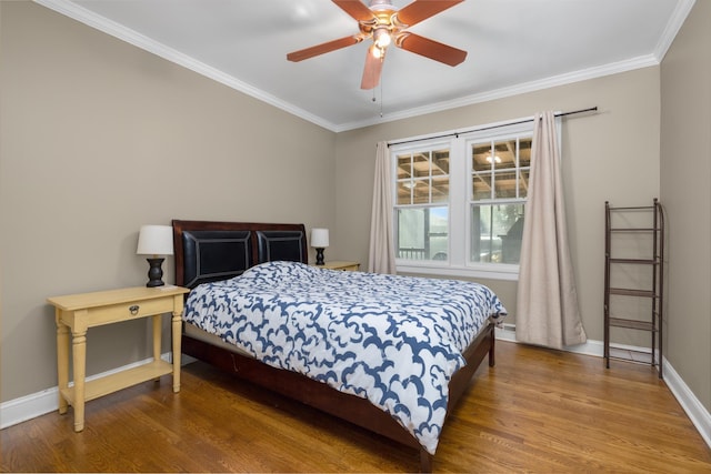 bedroom featuring hardwood / wood-style flooring, ceiling fan, and ornamental molding