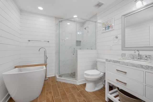 full bathroom featuring vanity, toilet, and shower with separate bathtub