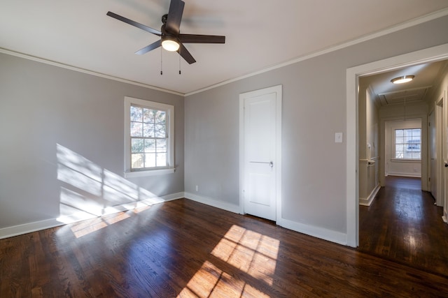 empty room featuring dark hardwood / wood-style floors, ceiling fan, and crown molding