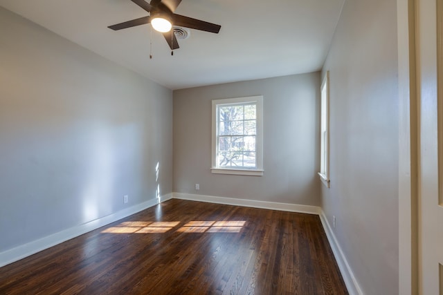 empty room featuring ceiling fan and dark hardwood / wood-style flooring