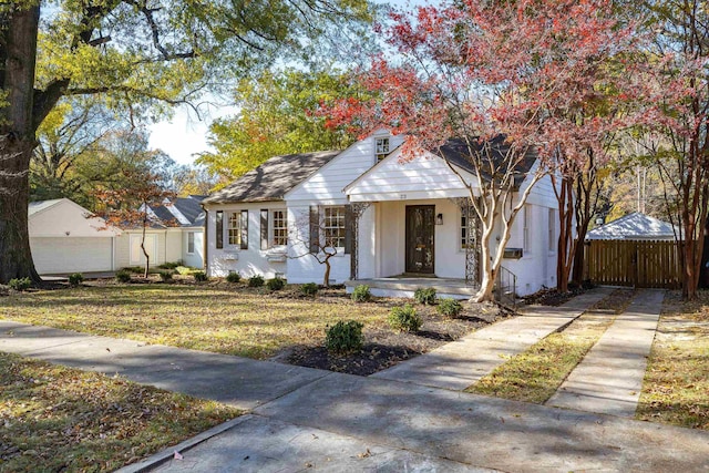 view of front of house with covered porch, an outdoor structure, and a garage