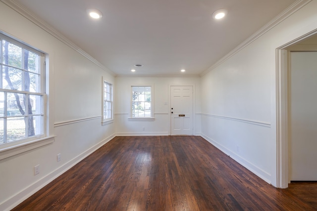 spare room featuring dark hardwood / wood-style floors and crown molding