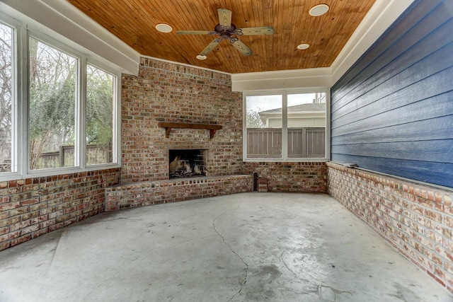 view of patio / terrace featuring ceiling fan and a brick fireplace