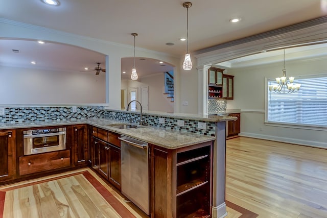 kitchen featuring backsplash, light stone countertops, and appliances with stainless steel finishes