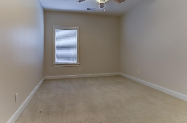 carpeted spare room with ceiling fan