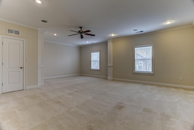 carpeted empty room with ceiling fan and crown molding