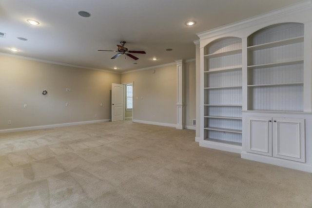 empty room featuring ceiling fan, light colored carpet, and ornamental molding