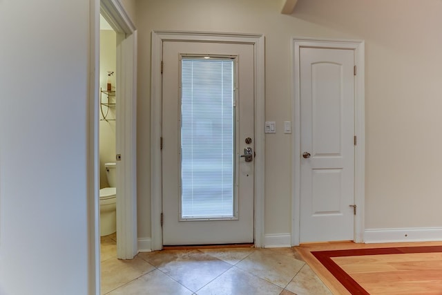 doorway to outside featuring light tile patterned floors