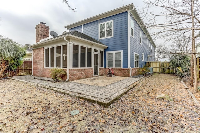 back of house featuring a sunroom and a patio area