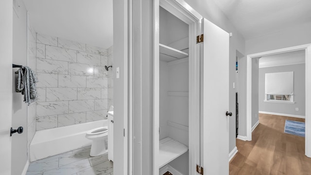 full bathroom with wood-type flooring, vanity, toilet, and tiled shower / bath