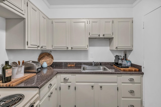 kitchen featuring range, white cabinetry, crown molding, and sink