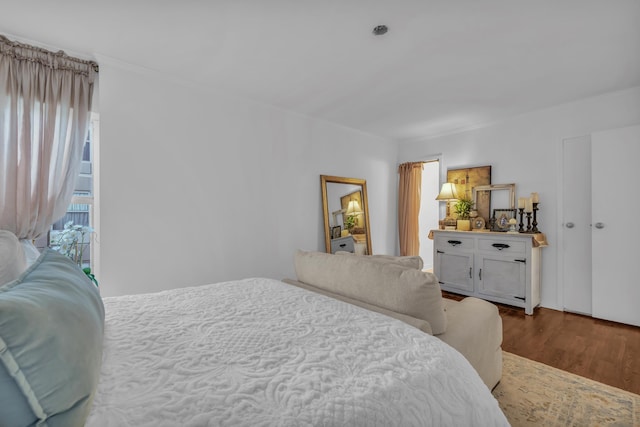 bedroom featuring hardwood / wood-style flooring and crown molding