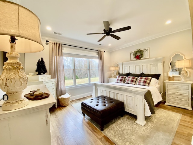 bedroom featuring ceiling fan, wood-type flooring, and ornamental molding