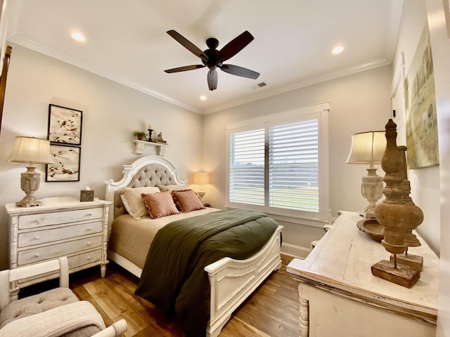 bedroom with ceiling fan, hardwood / wood-style floors, and ornamental molding