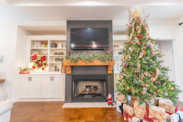 living room featuring a large fireplace and hardwood / wood-style flooring