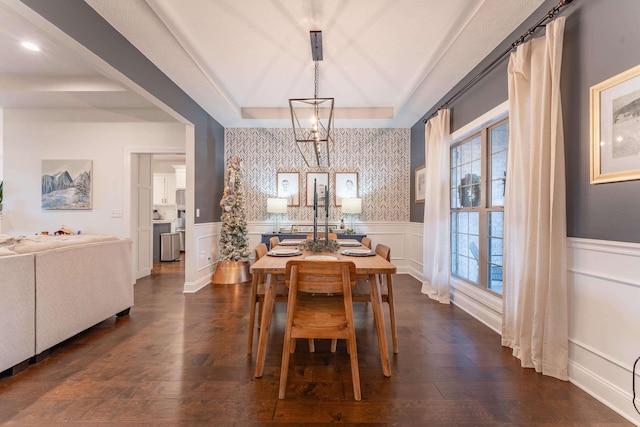 dining area featuring dark hardwood / wood-style floors and a raised ceiling